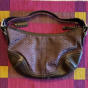 Gently used purple and brown small Coach purse.